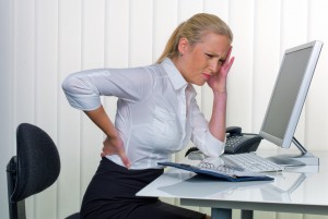 women in the office with back pain